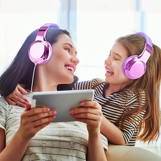 Deux enfants avec casque audio rose sur tablette