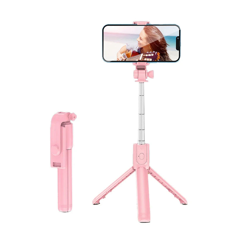 Perche à selfie pliable rose avec support extensible pour téléphone portable, parfaite pour capturer des photos colorées, vidéos ou selfies en voyage.